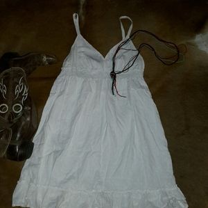 A white dress with For Colored beaded necklace